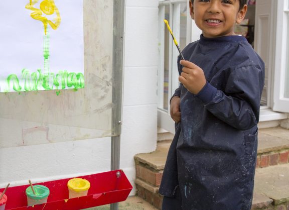boy painting outside